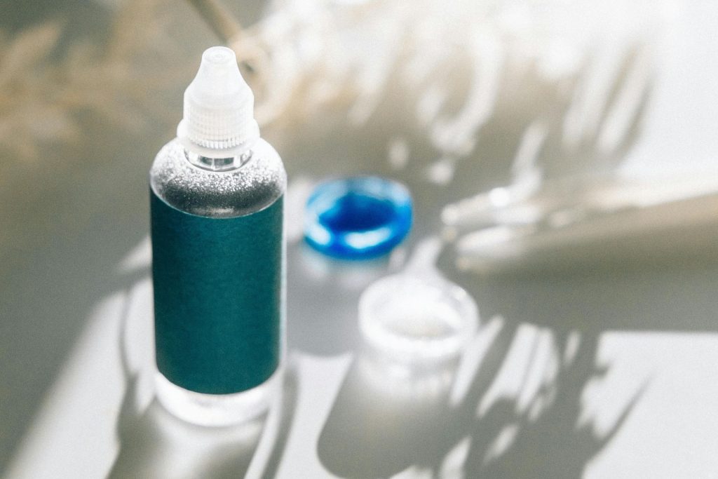 Eye drop and eye lens case in the sun