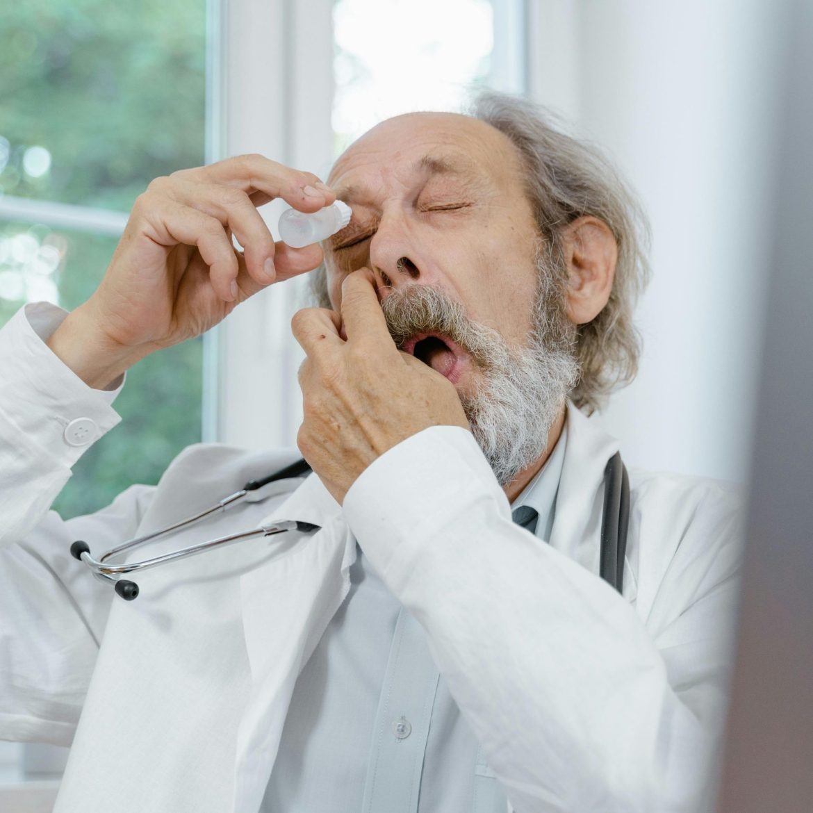 Old man using an eye drop