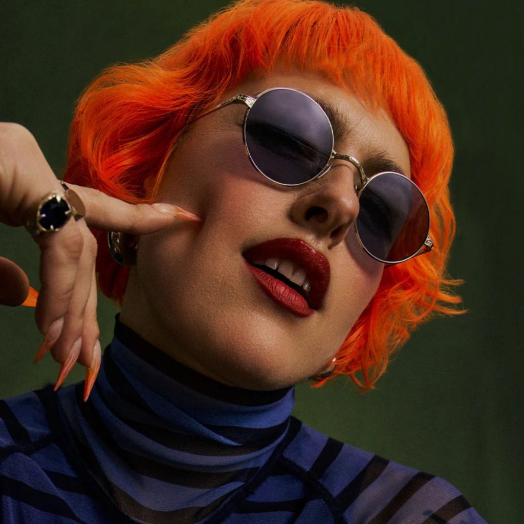 Woman with orange hair wearing GLCO x Ozzy Osbourne round fram