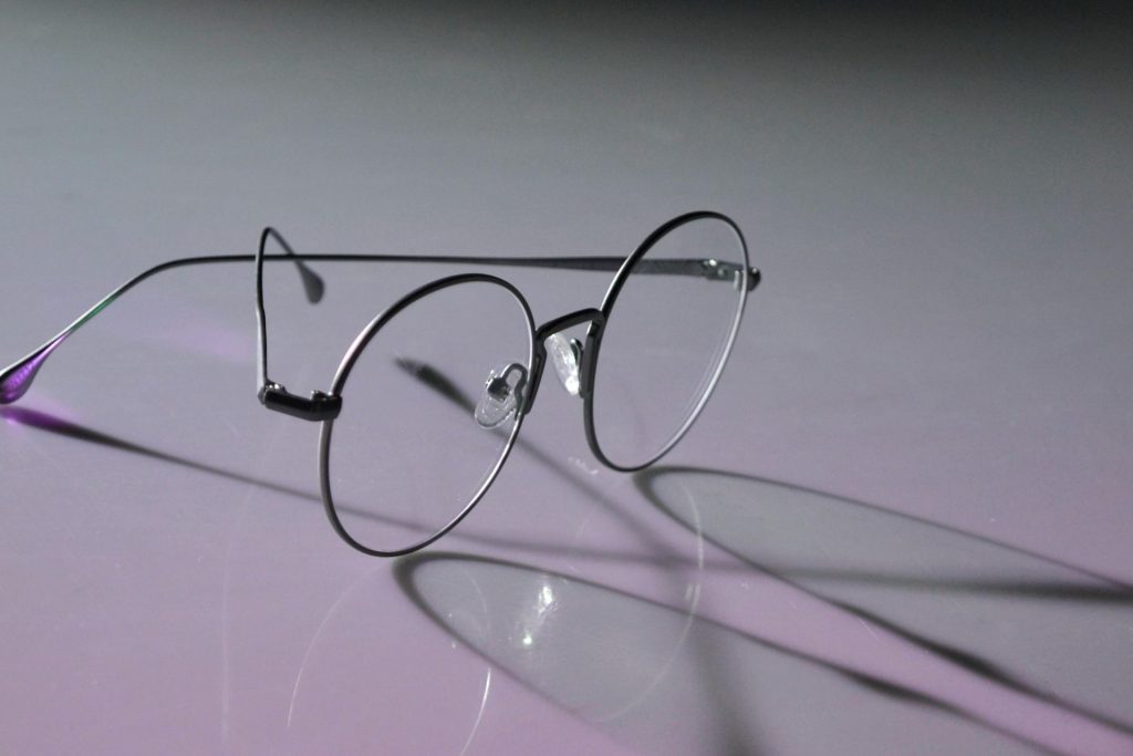 Wire rimmed glasses, reflected on a surface