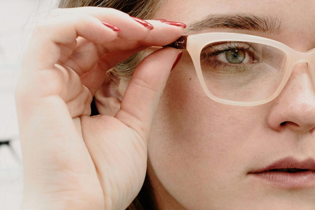 Woman tries on glasses in an optical center