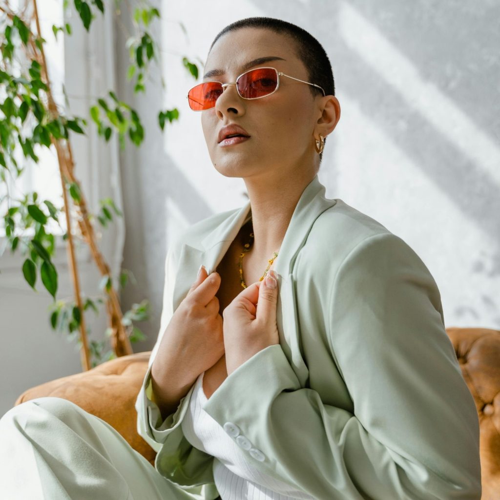 Woman in a business suit, wearing red-tinted glasses