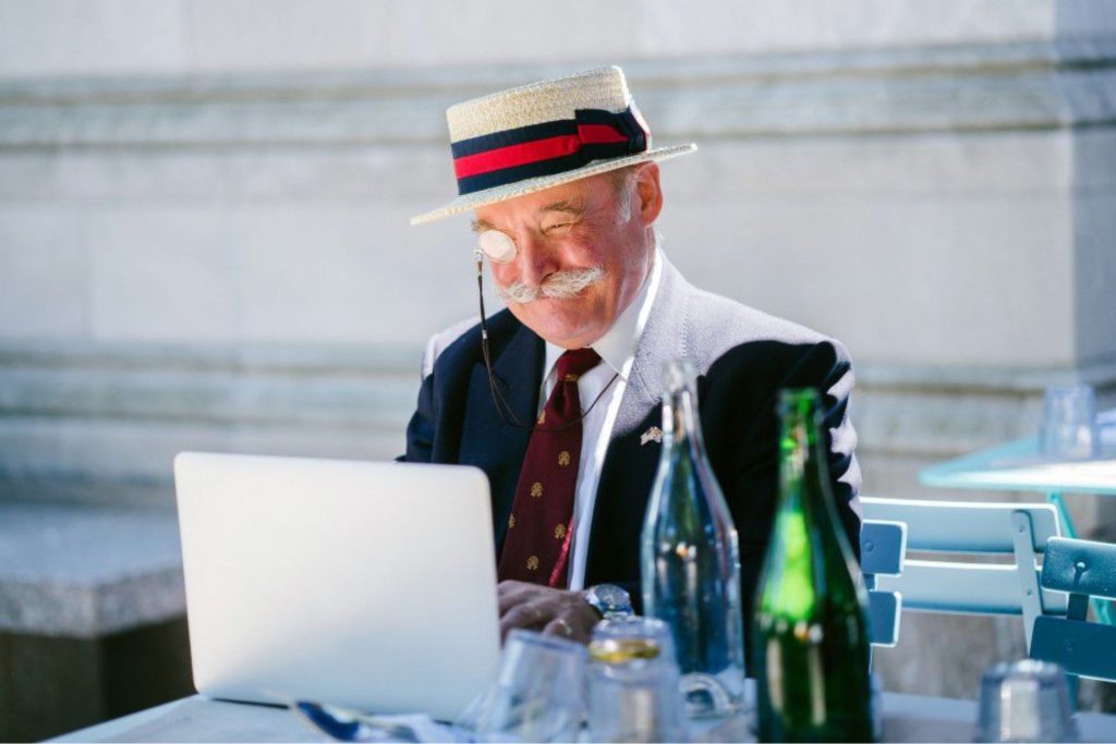 Man in monocle works on computer