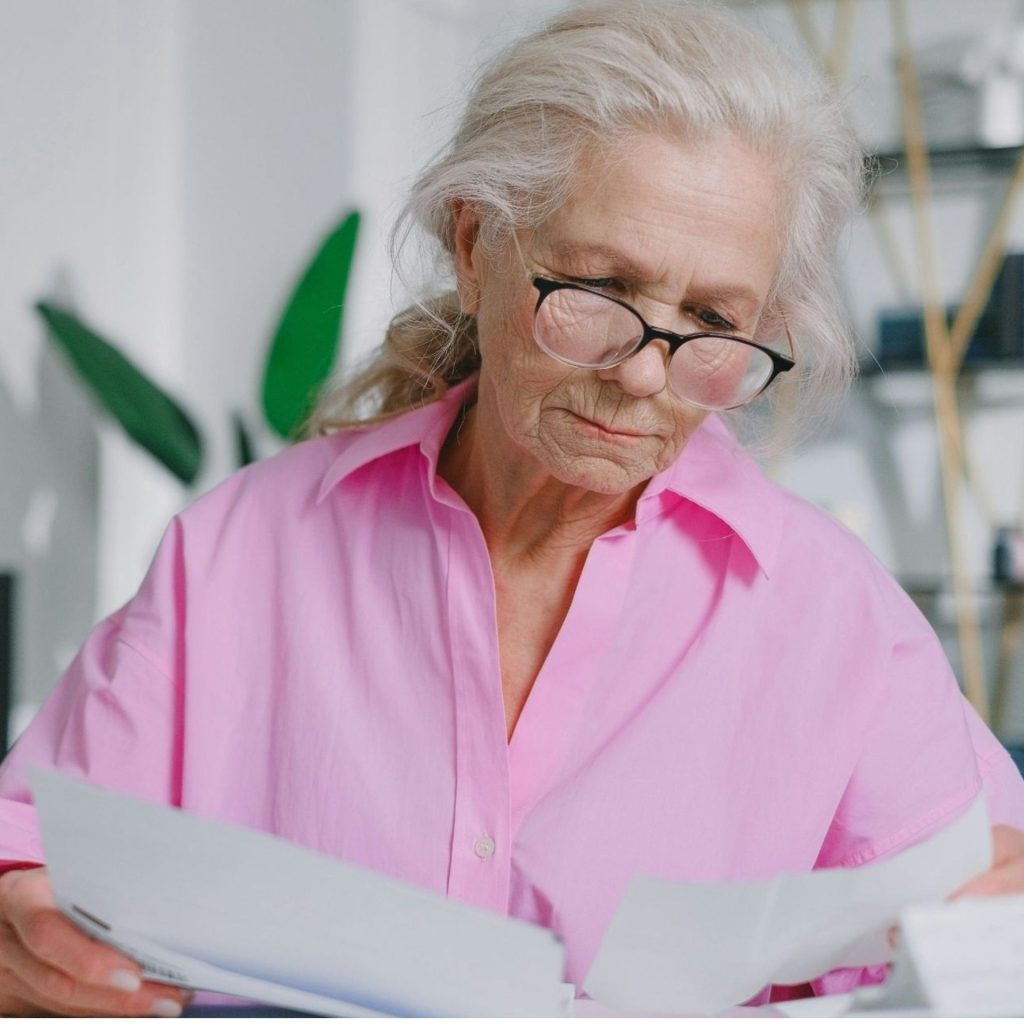 Woman reading documents with glasses