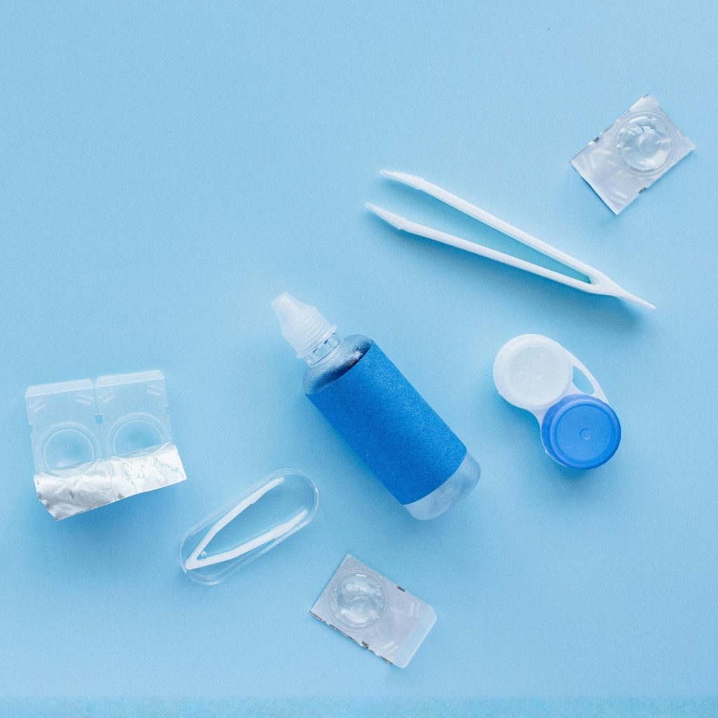 Contact lenses and solution on blue background