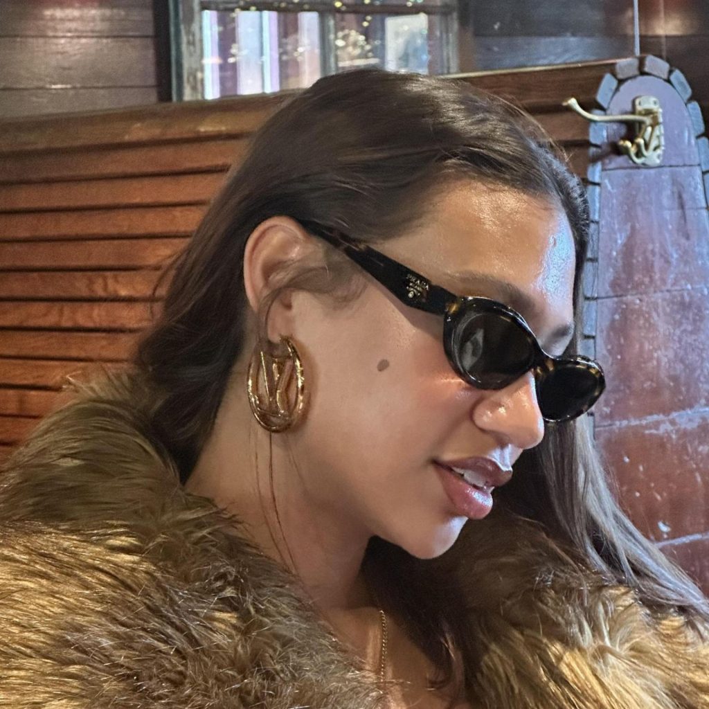 Prada PR 26ZS sunglasses featuring black frames and dark gray lenses