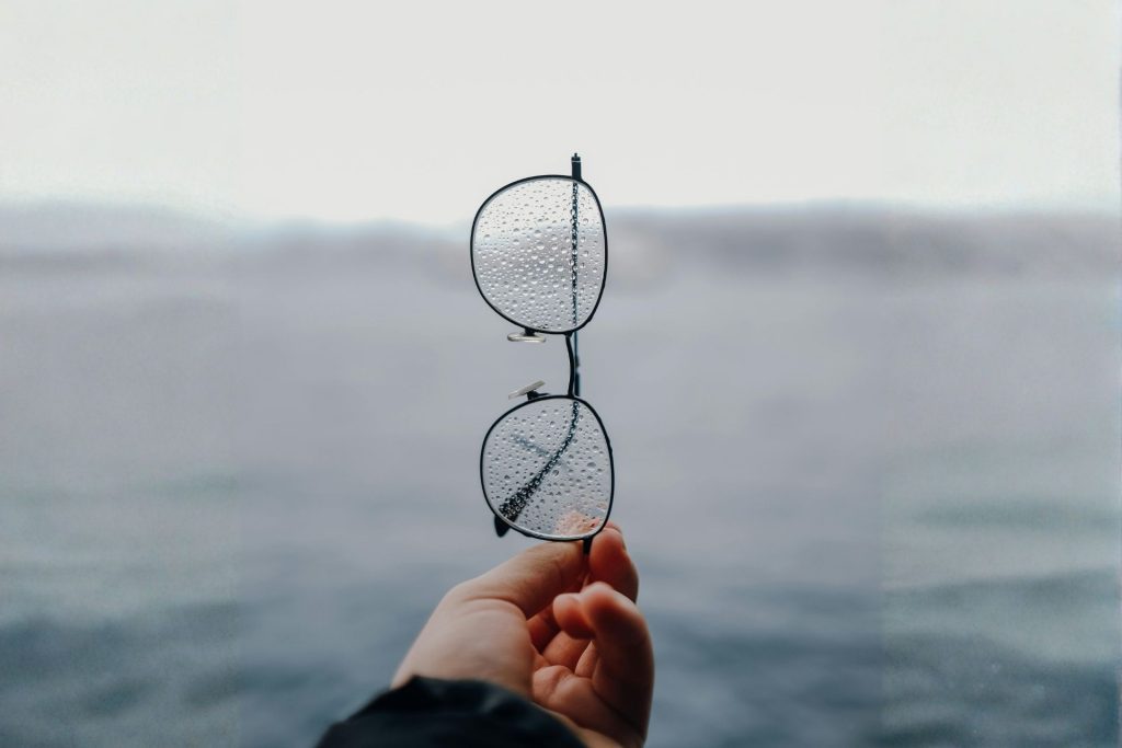 Person examines their glasses