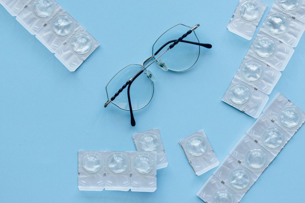 Contact lenses and glasses on table