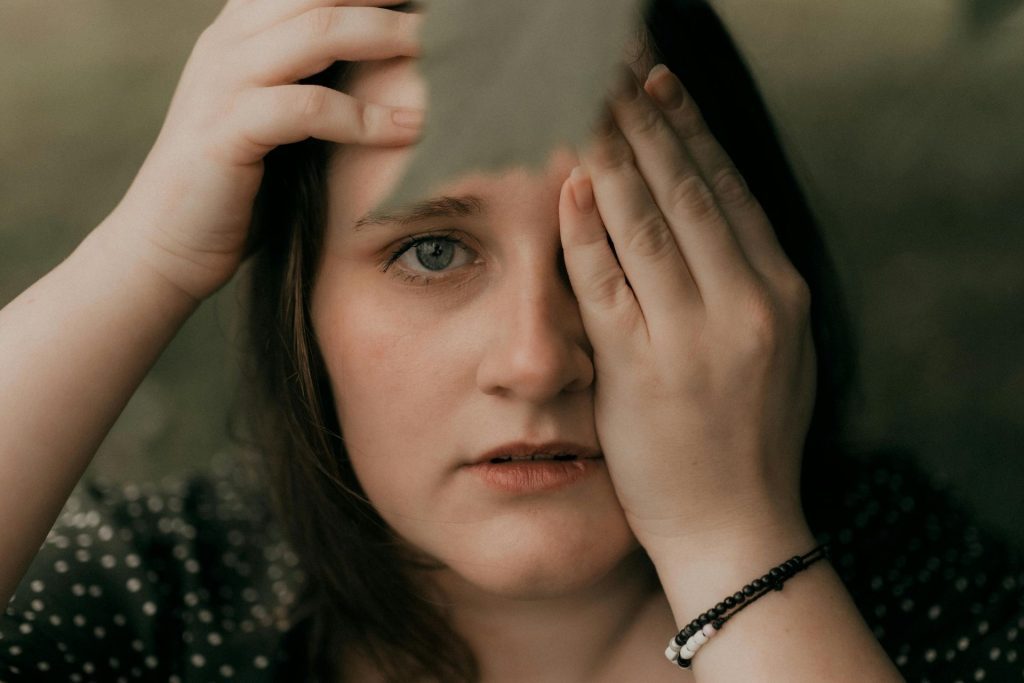 Woman covers her eye
