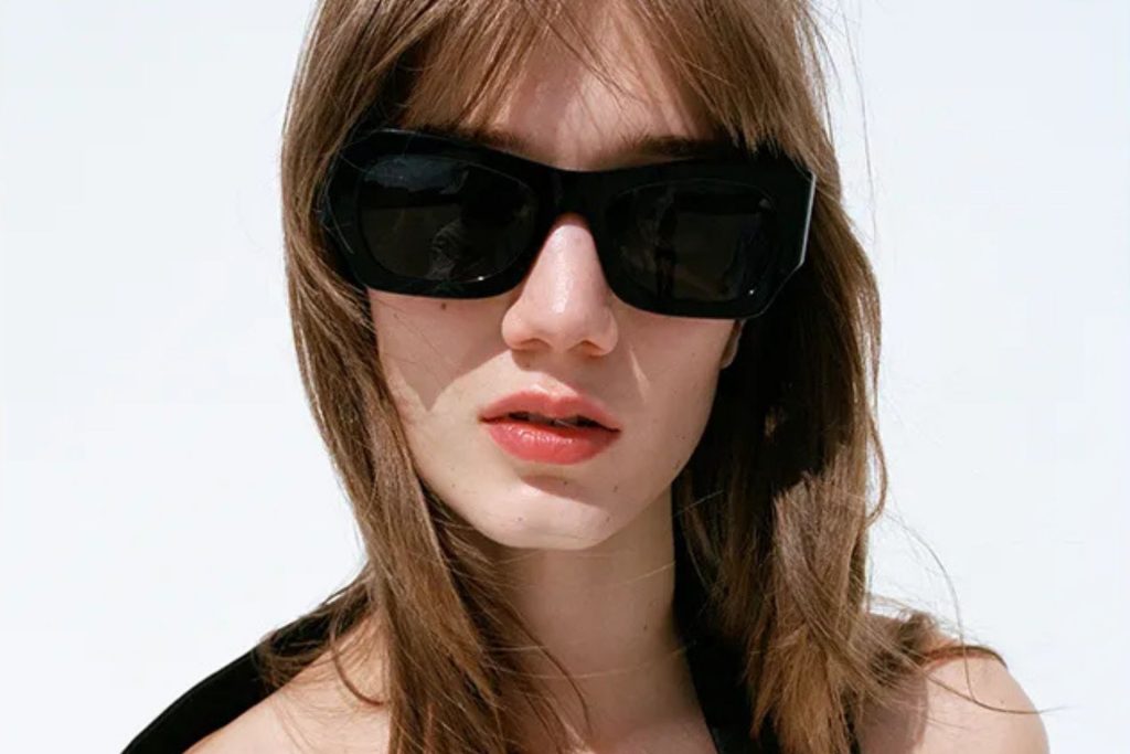 Model wearing oversized black CELINE sunglasses