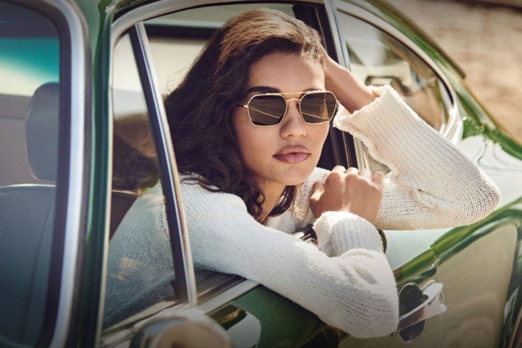 Model wearing geometric Oliver Peoples aviator sunglasses