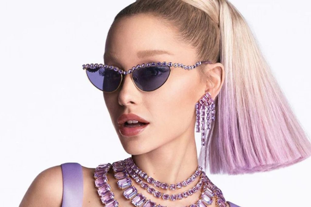 Ariana Grande wearing Swarovski jewelry and purple-tinted sunglasses