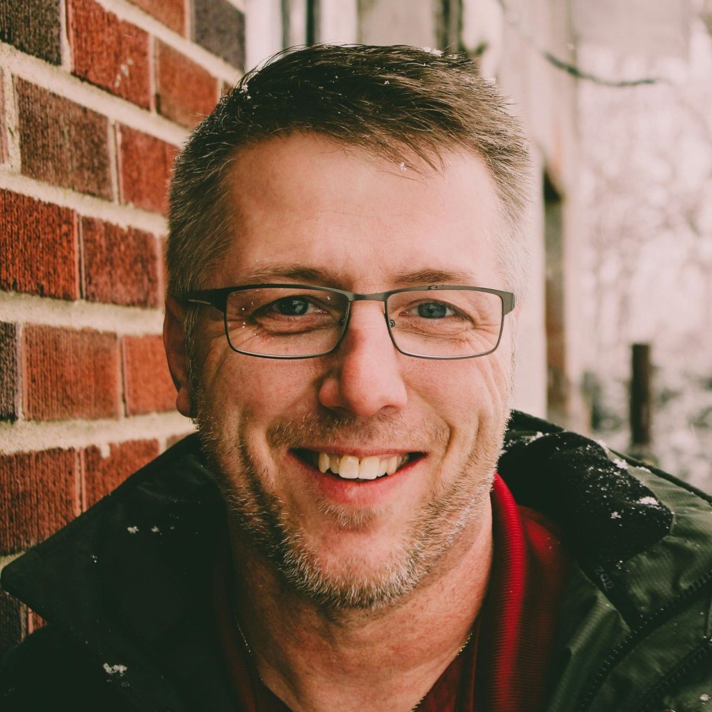 Man wearing metallic glasses, outdoors while snowing