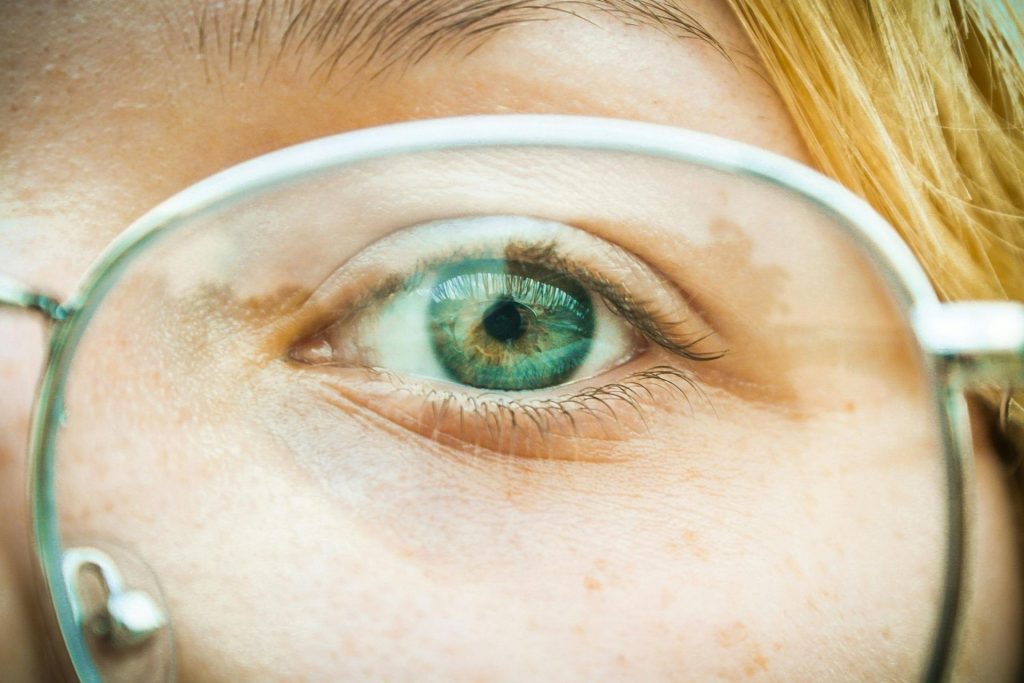 Close-up of a person’s eye through their eyeglasses