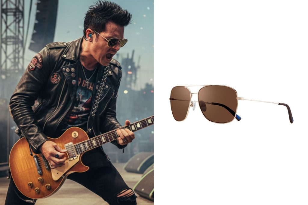 A lead guitarist wearing sunglasses at a concert