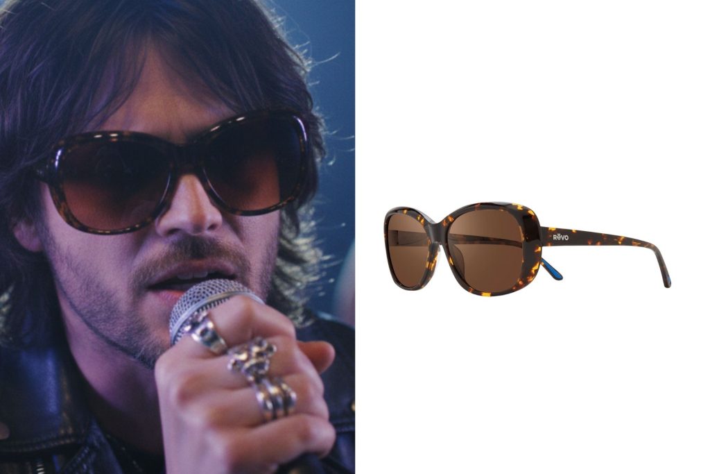 A singer wearing sunglasses at a concert