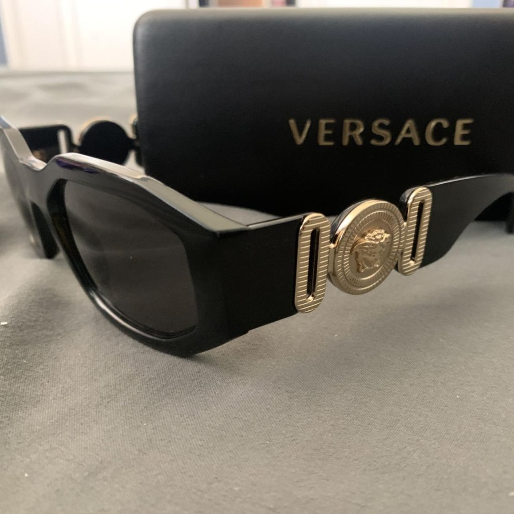 Versace VE4361 sunglasses featuring black and gold frames