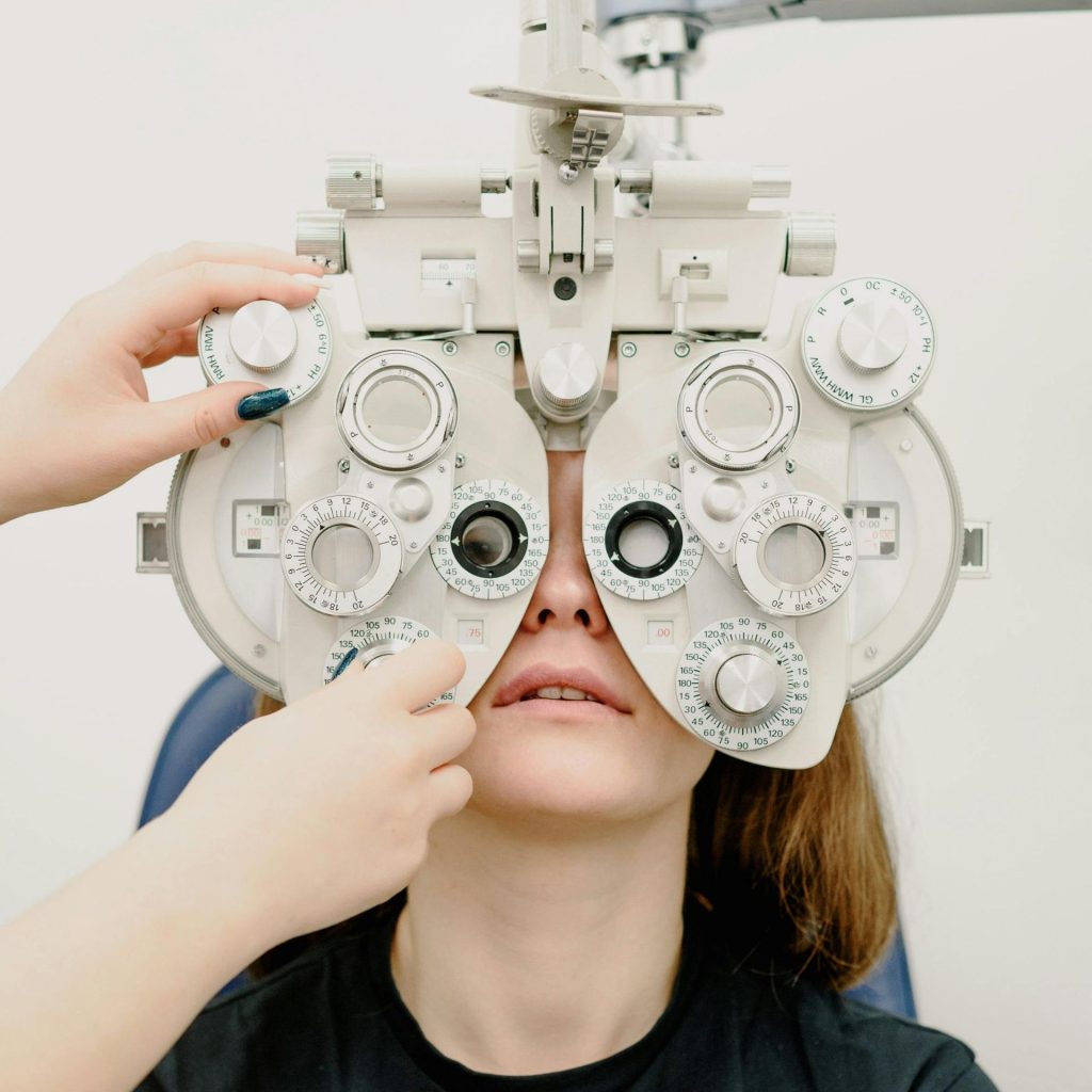 Doctor examining woman's vision using phoropter
