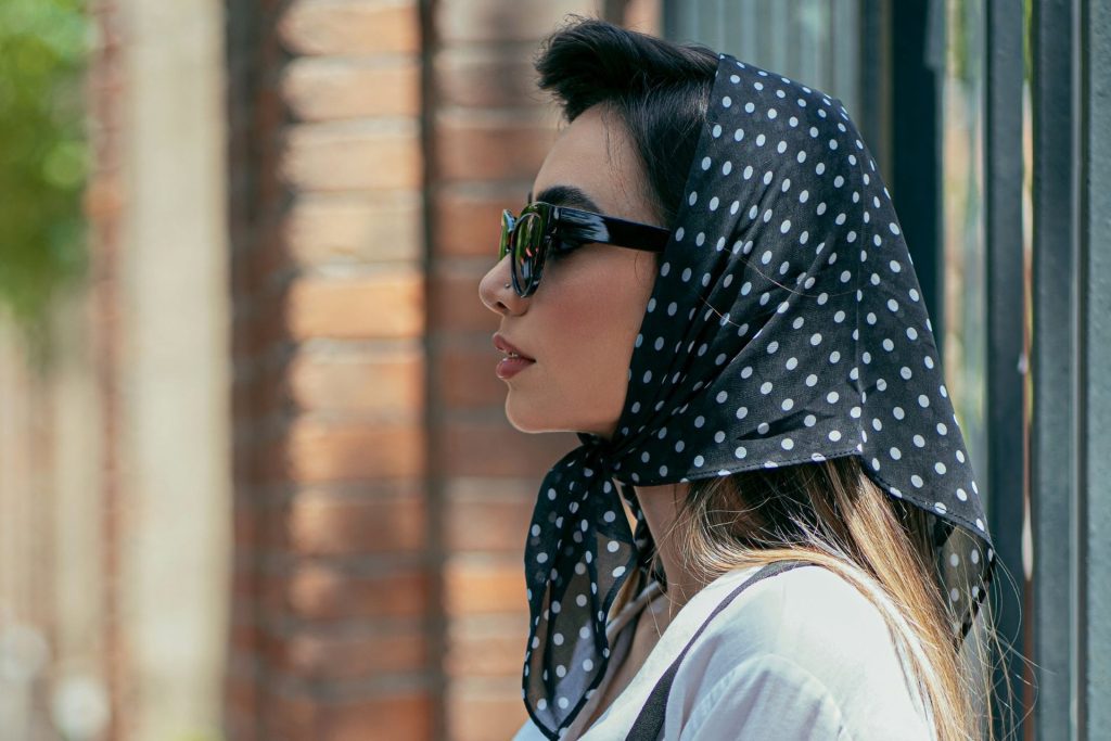 Woman wearing a black and white polka dot silk scarf