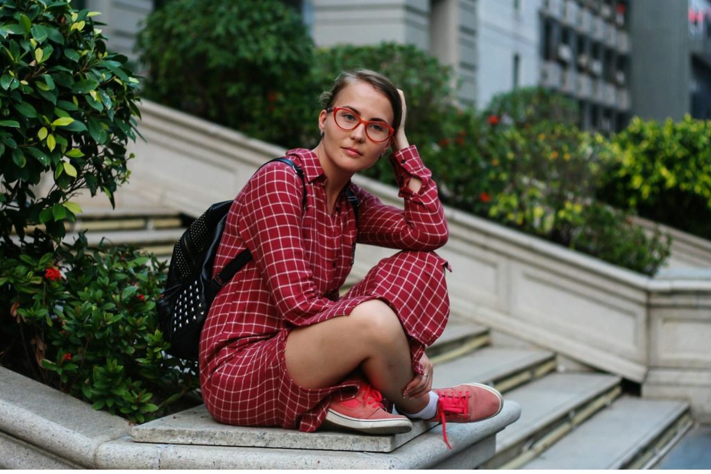 Woman wears red cat-eye glasses