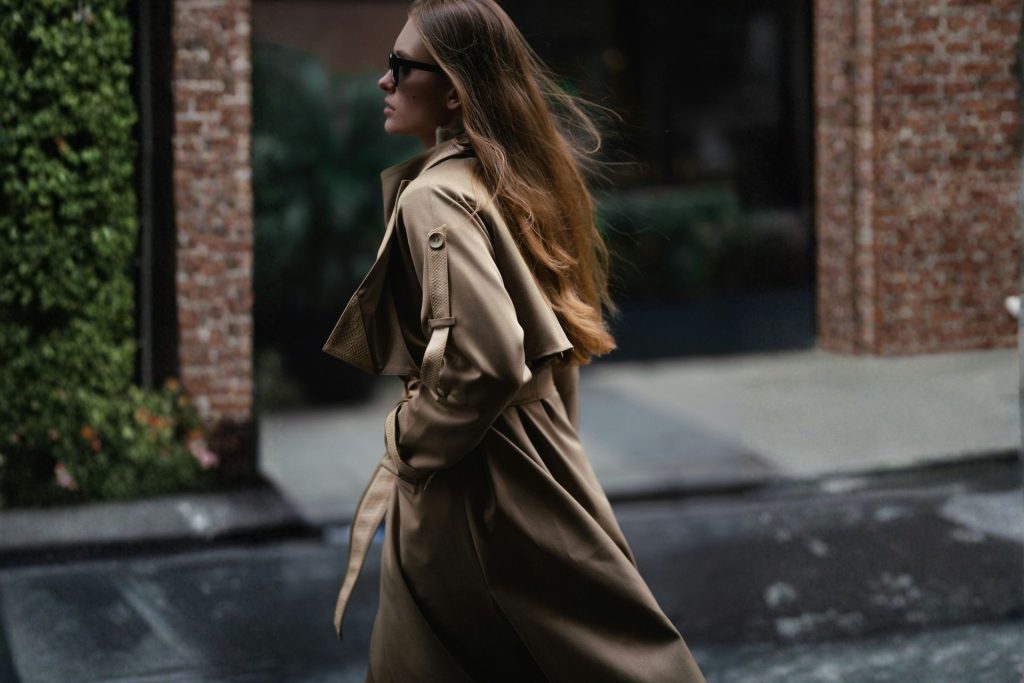Woman walking in a trench coat