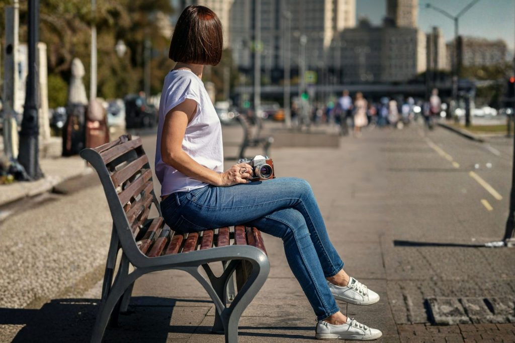 Woman wearing blue jeans and a white tee