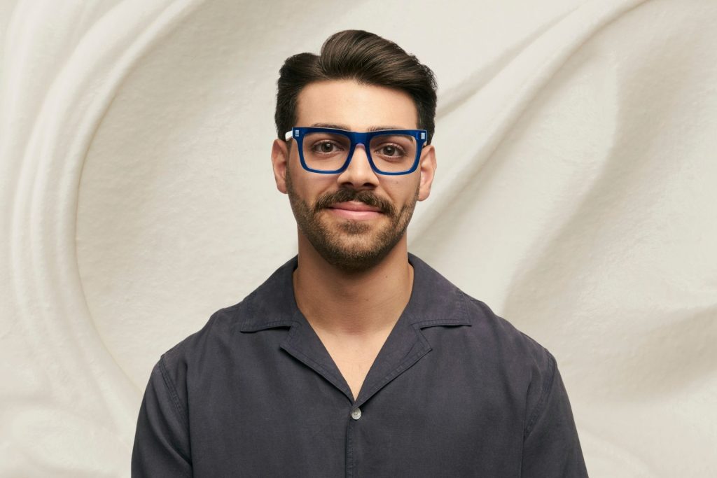 Man wearing blue square glasses
