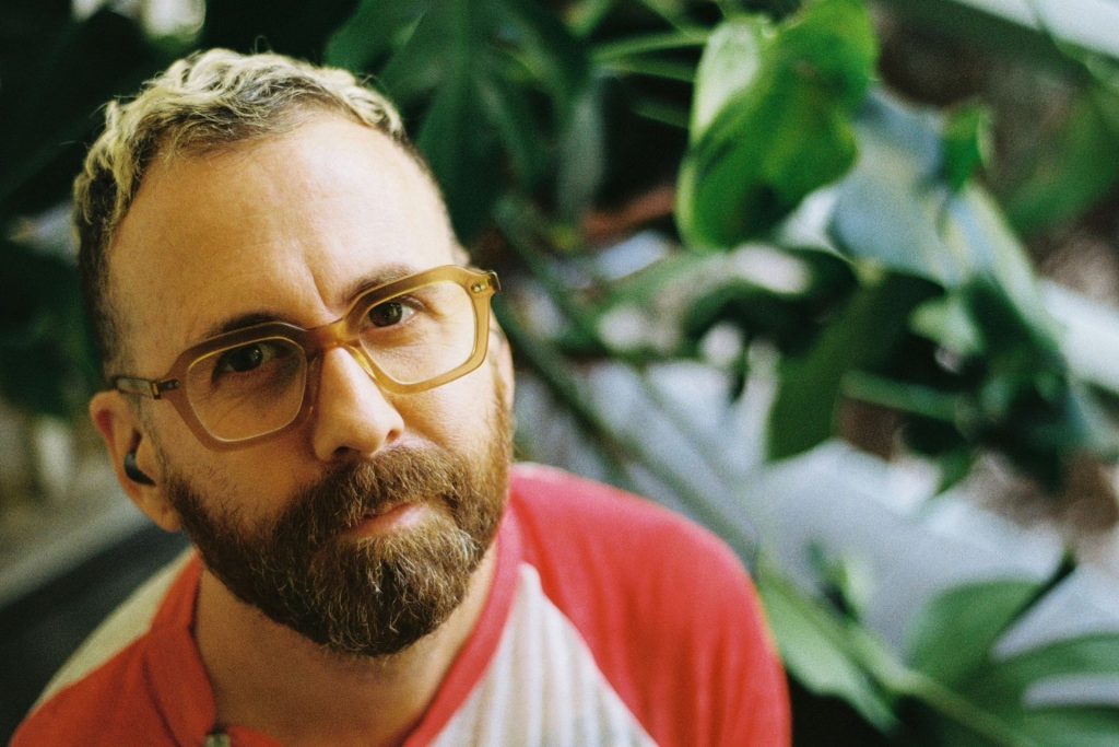 Man wearing transparent-framed square glasses