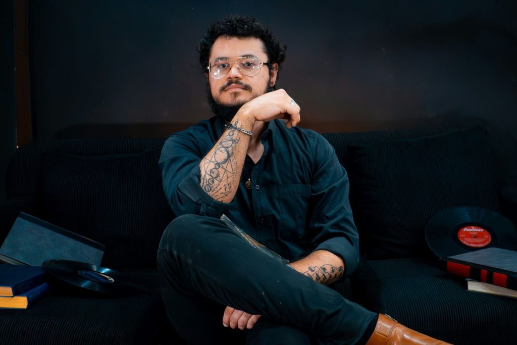 Man with a round face wearing glasses