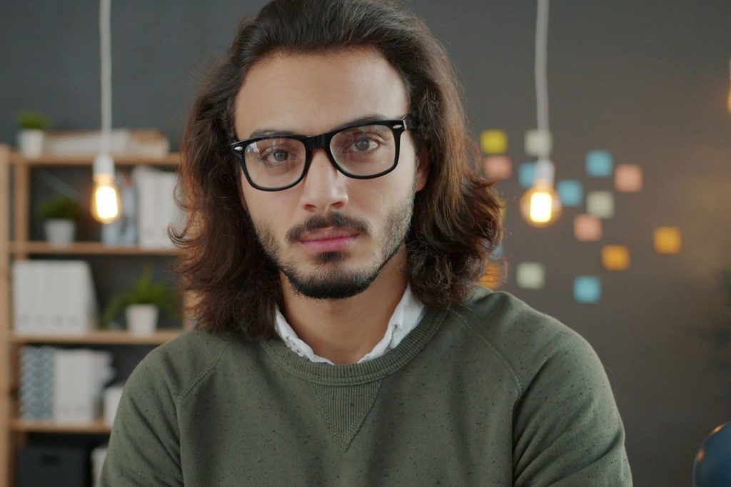 Man wearing black thick horn-rimmed glasses