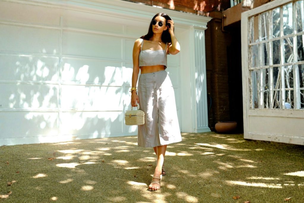 Woman wearing a summer outfit and round shades