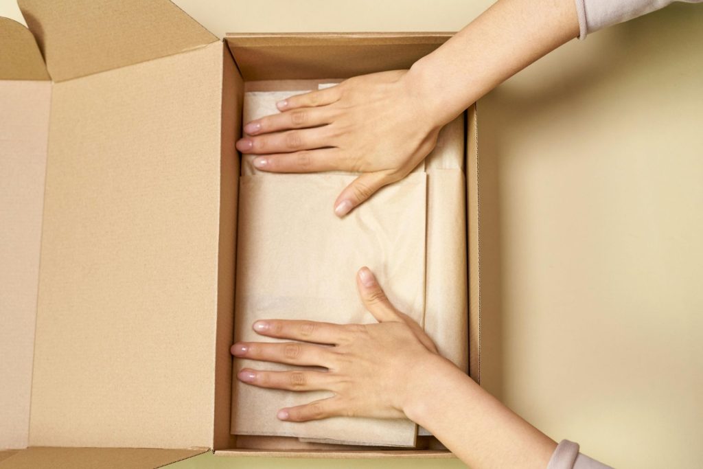Hands in a cardboard box
