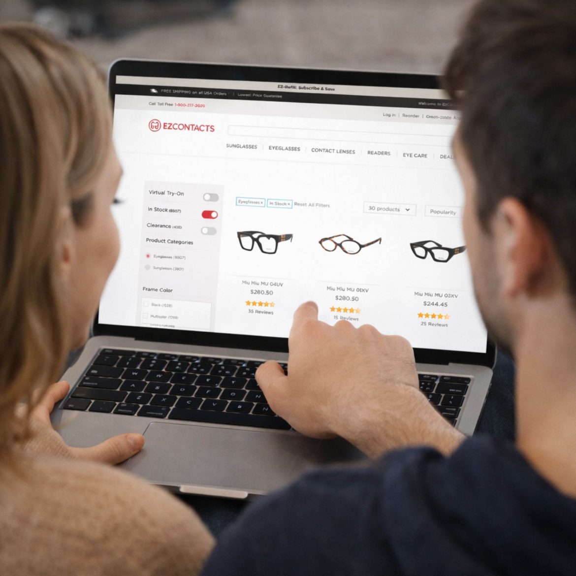 Person scrolling glasses on their laptop