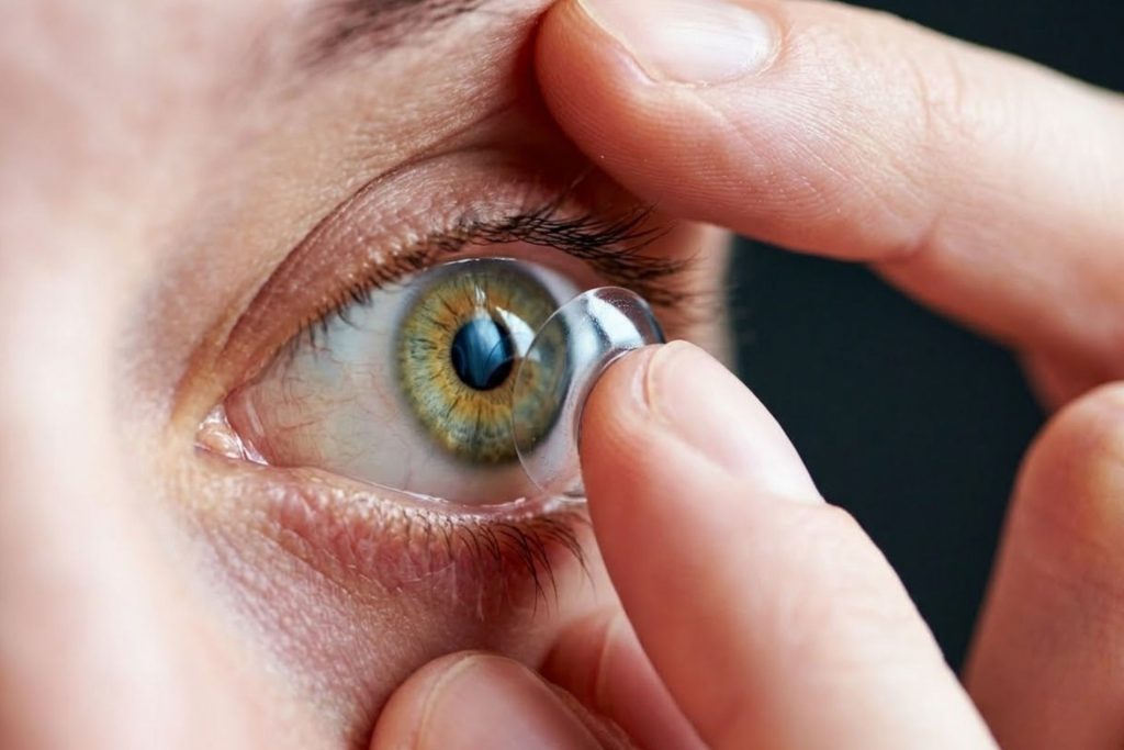Close-up of woman putting contact lens in her eye