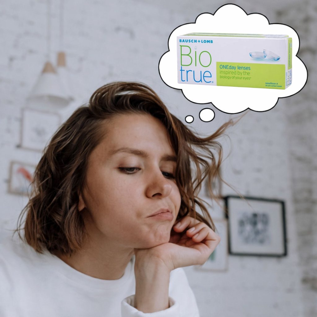Woman thinking about BioTrue contact lenses