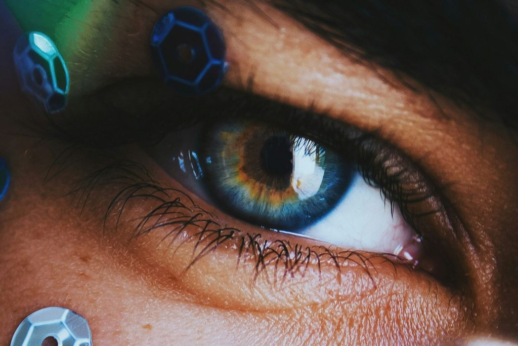 Person wearing bold makeup and blue contact lenses