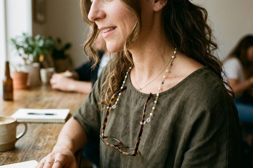 Woman wearing a beaded eyeglass chain