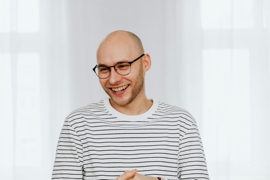 Man wears glasses and smiles