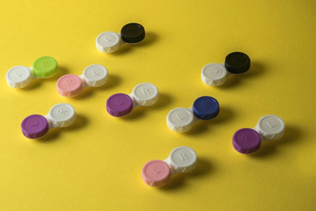 Contact lens cases on a yellow background
