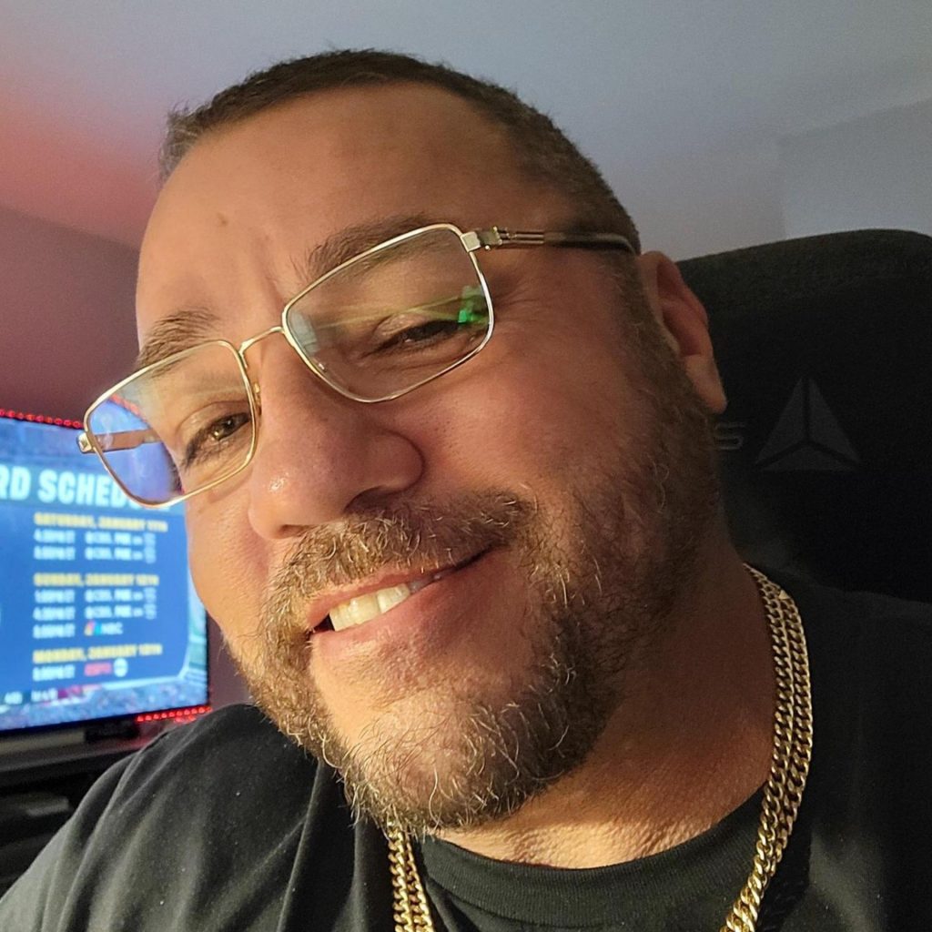 Man wears gold-framed Gucci GG1291O glasses