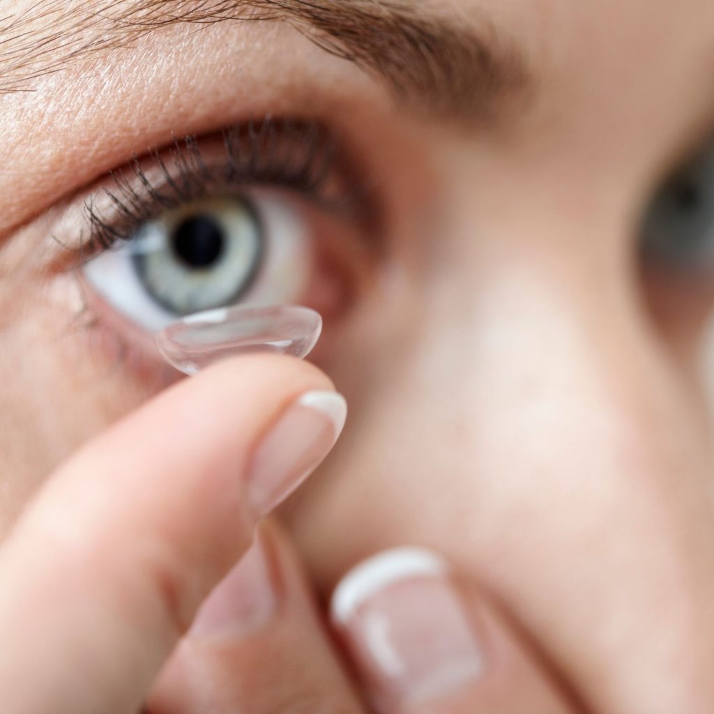 Woman putting in contact lens