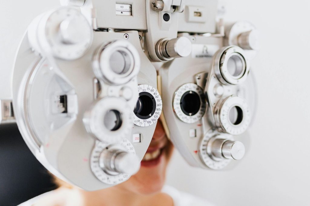 Woman getting an eye exam with a phoropter