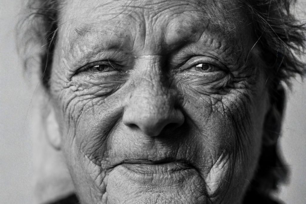 Close-up of an elderly woman in black-and-white