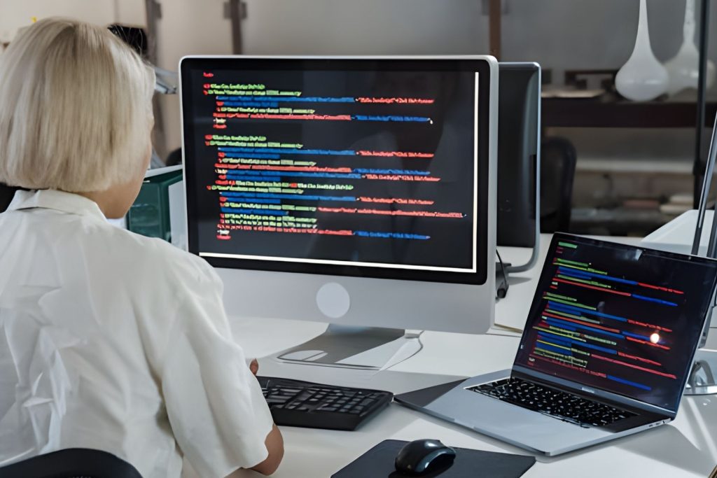 Woman looking at code on her computer