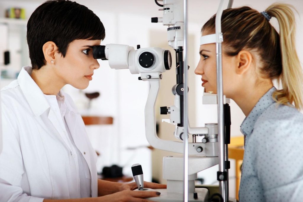 Eye doctor giving woman an eye exam