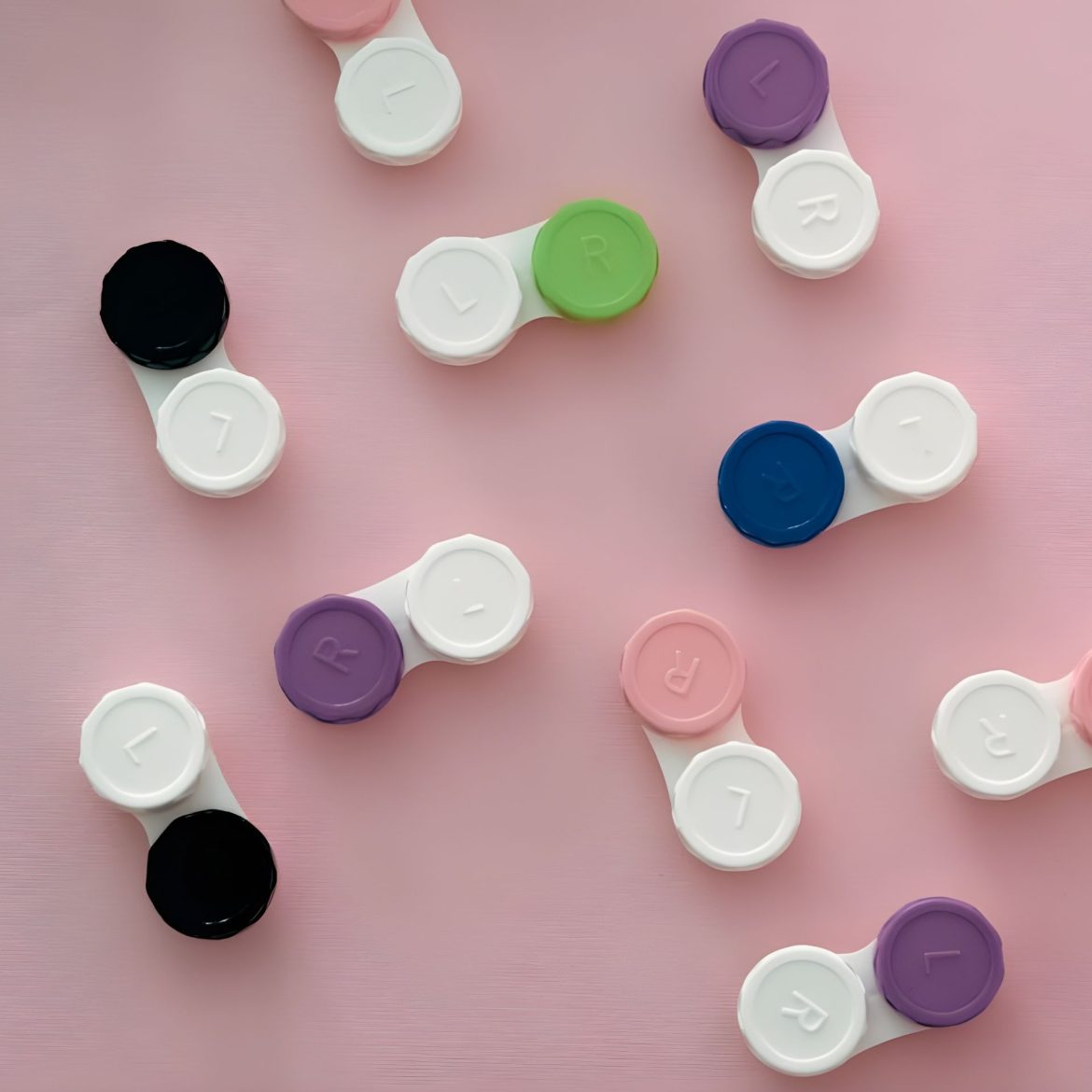 Contact lens cases on a pink background