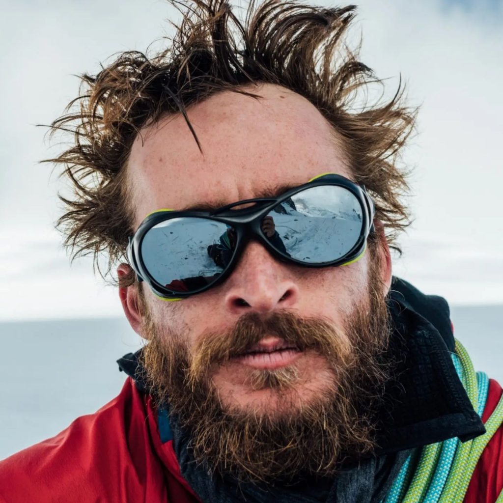 Man in glacier glasses in the snow