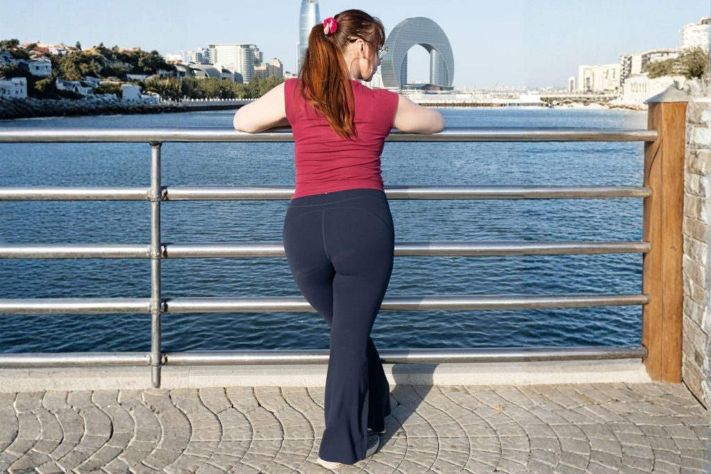 Woman wearing flared leggings next to the water