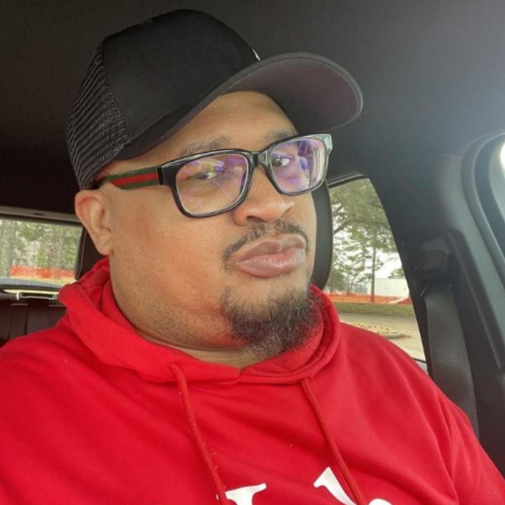 Man wearing Gucci GG0343o glasses and a red sweatshirt