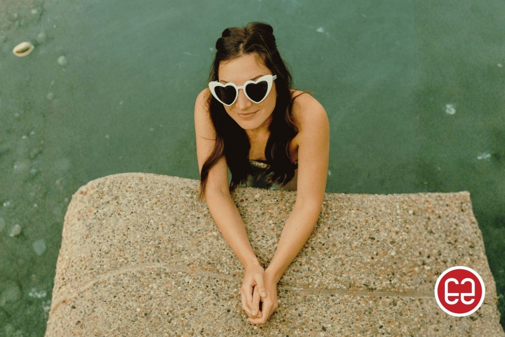 Woman wearing white heart-shaped sunglasses